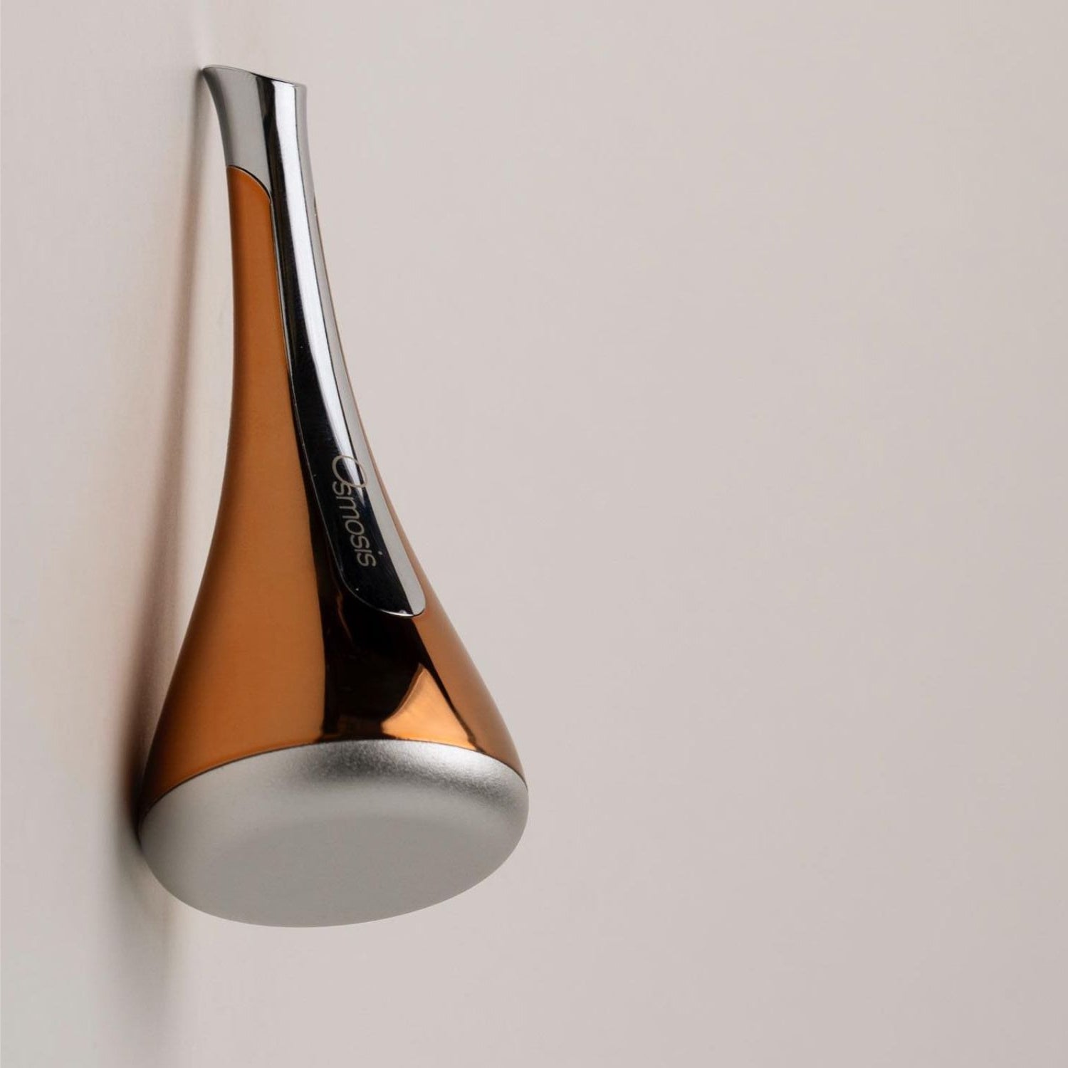 Osmosis cool skin tool laying on its side with a white background