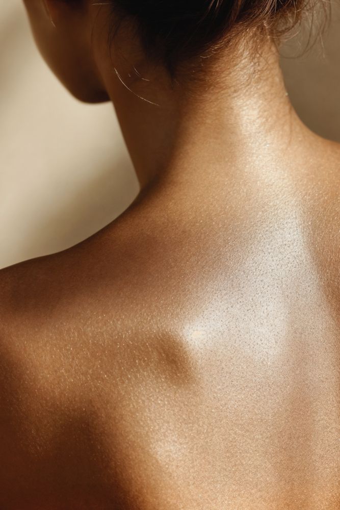 Close-up of a person's back with a blurred background