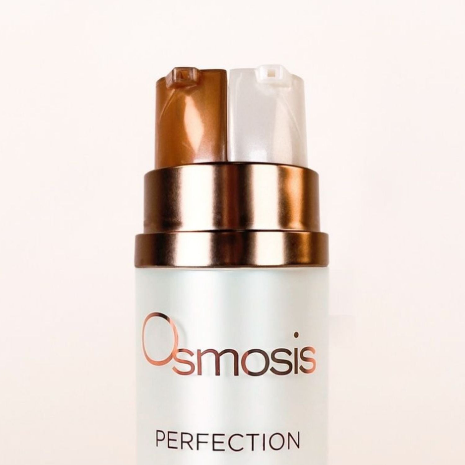 Close up of osmosis perfection dual pumps on the top of the bottle displayed on a white background