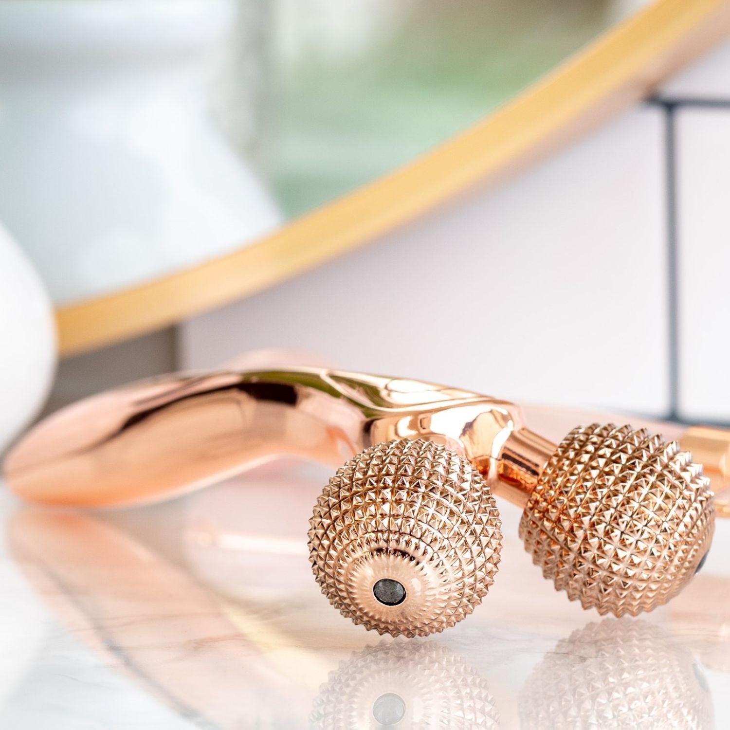 side ways views of rose gold epic skin tool displayed on counter